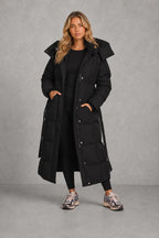 Robyn | Belted Longline Quilted Coat — lifestyle — Sofia [5acfbd73-bfbf-4844-90e7-dc15a66690aa]
